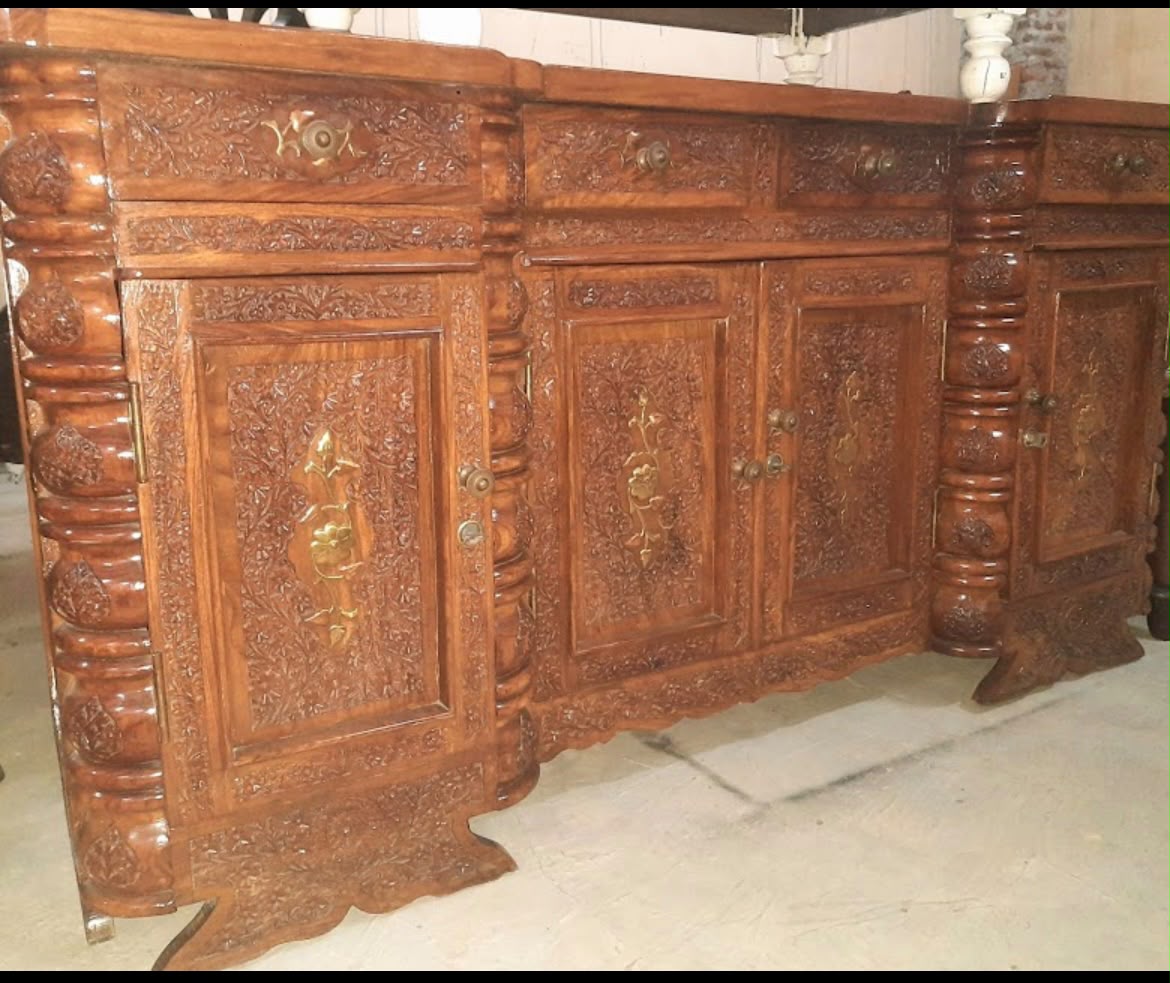 Hand-carved wooden sideboard with brass fittings